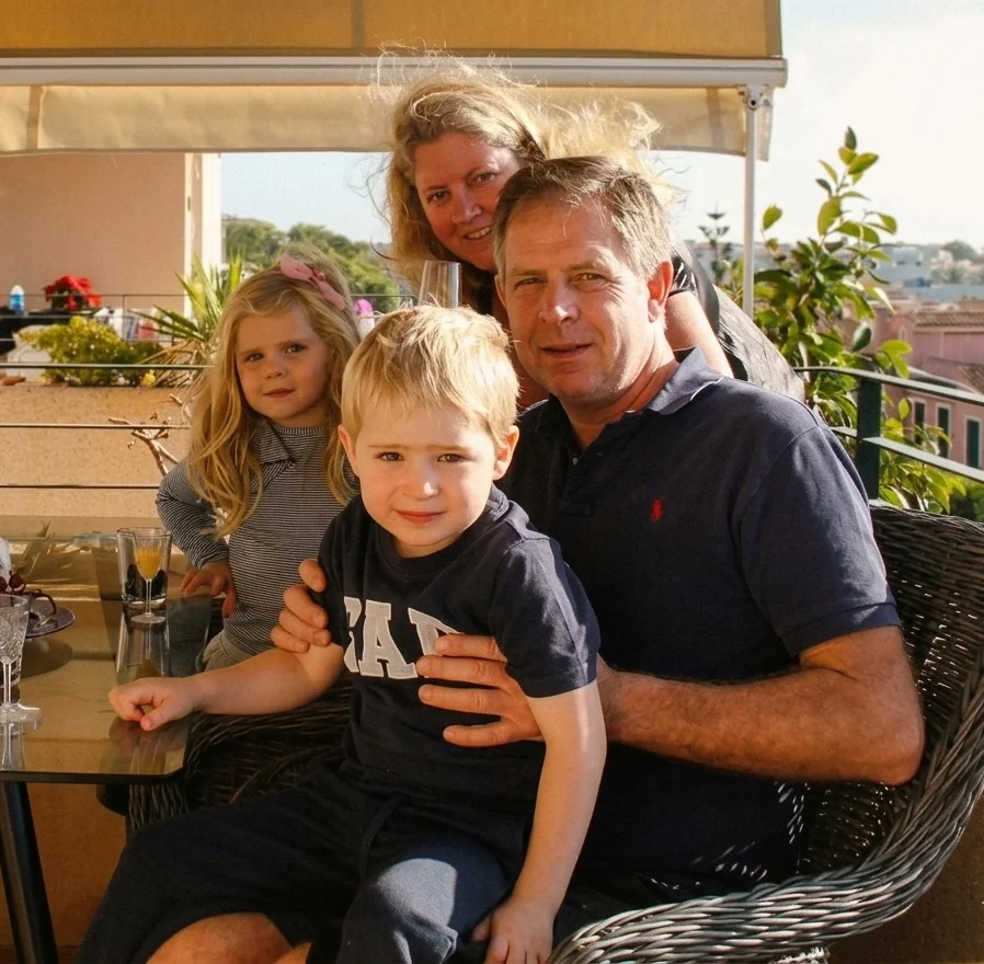 Family of four together at home